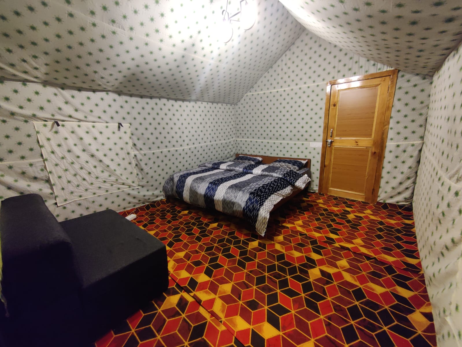 Interior of a Kasol camp room with a bed and seating